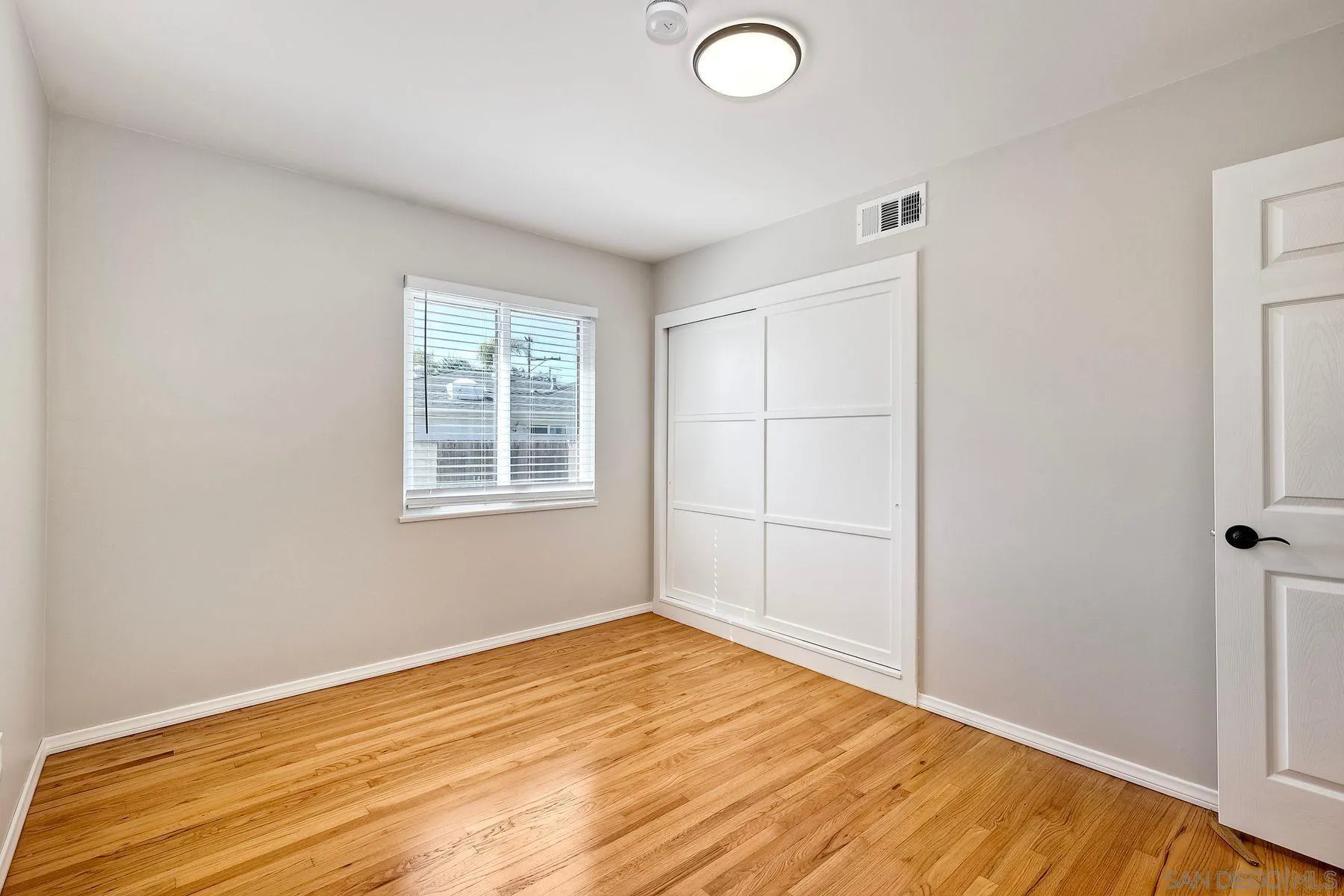 9307 Manor Drive La Mesa, CA 91942 - Photo 13 of 29 a view of empty room with wooden floor and fan