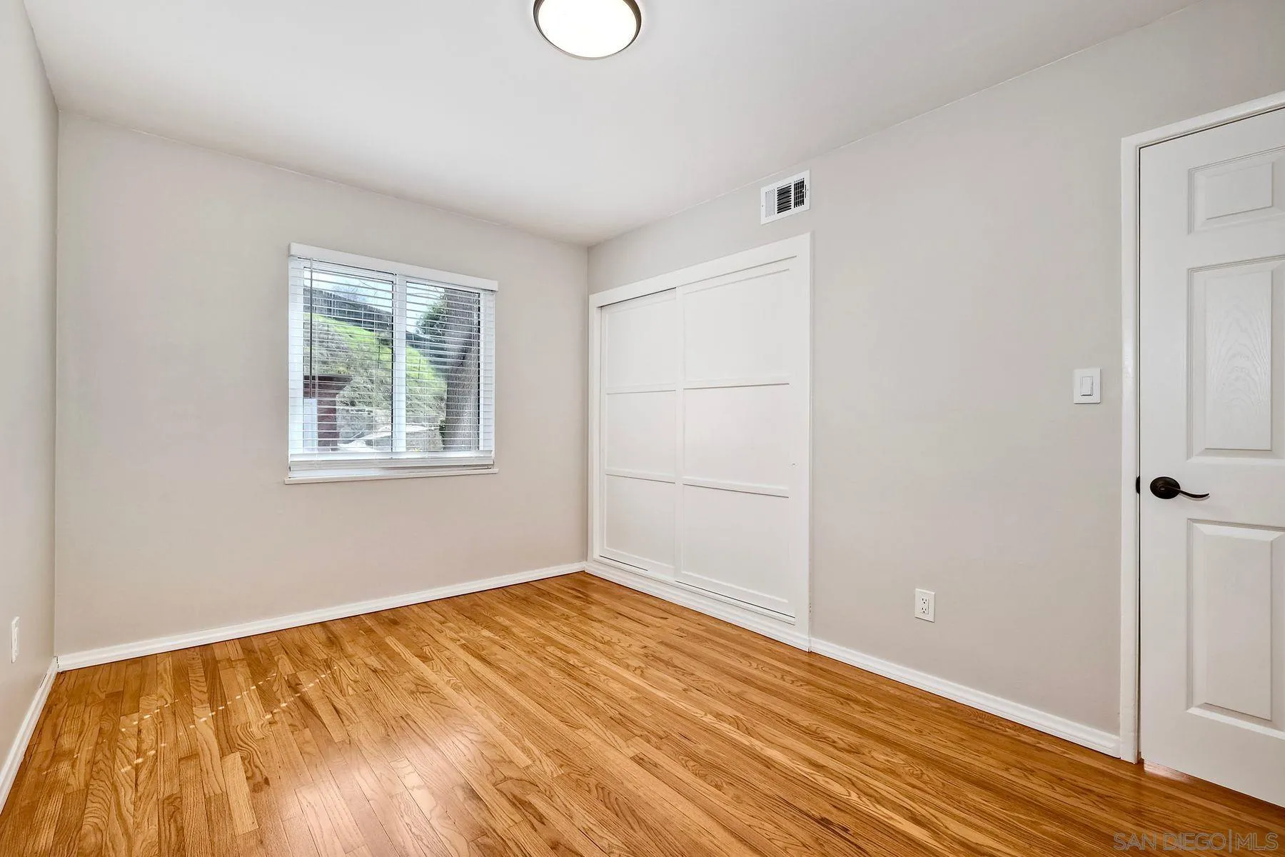 9307 Manor Drive La Mesa, CA 91942 - Photo 16 of 29 a view of empty room with wooden floor