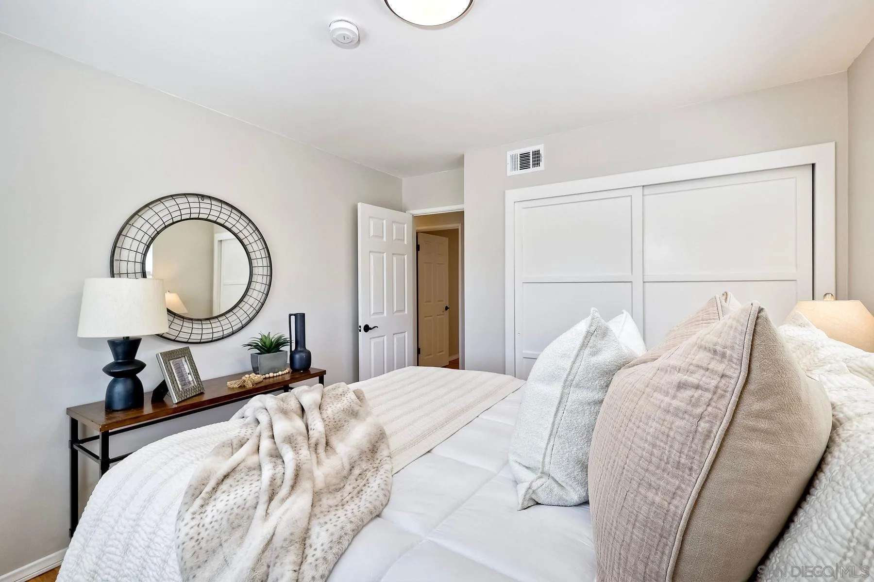 9307 Manor Drive La Mesa, CA 91942 - Photo 20 of 29 a bed sitting in a bedroom next to a bathroom sink