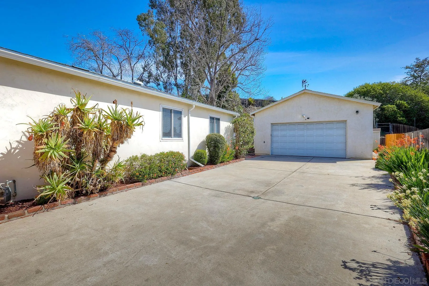 9307 Manor Drive La Mesa, CA 91942 - Photo 28 of 29 a front view of a house with garden