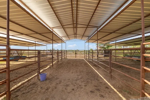 a view of a dry yard with wooden fence