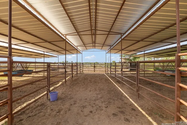 a view of a dry yard with wooden fence