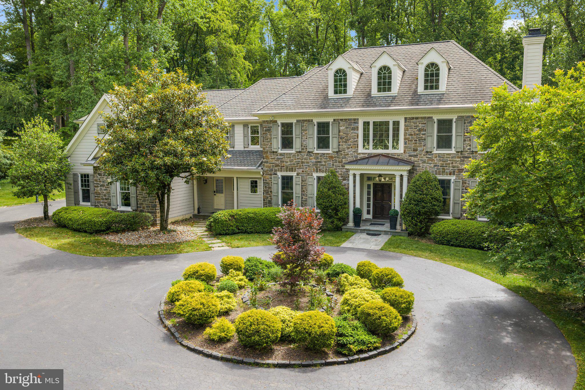 429 Church Road Devon, PA 19333 - Photo 3 of 55 Elegant stone home amidst lush greenery.