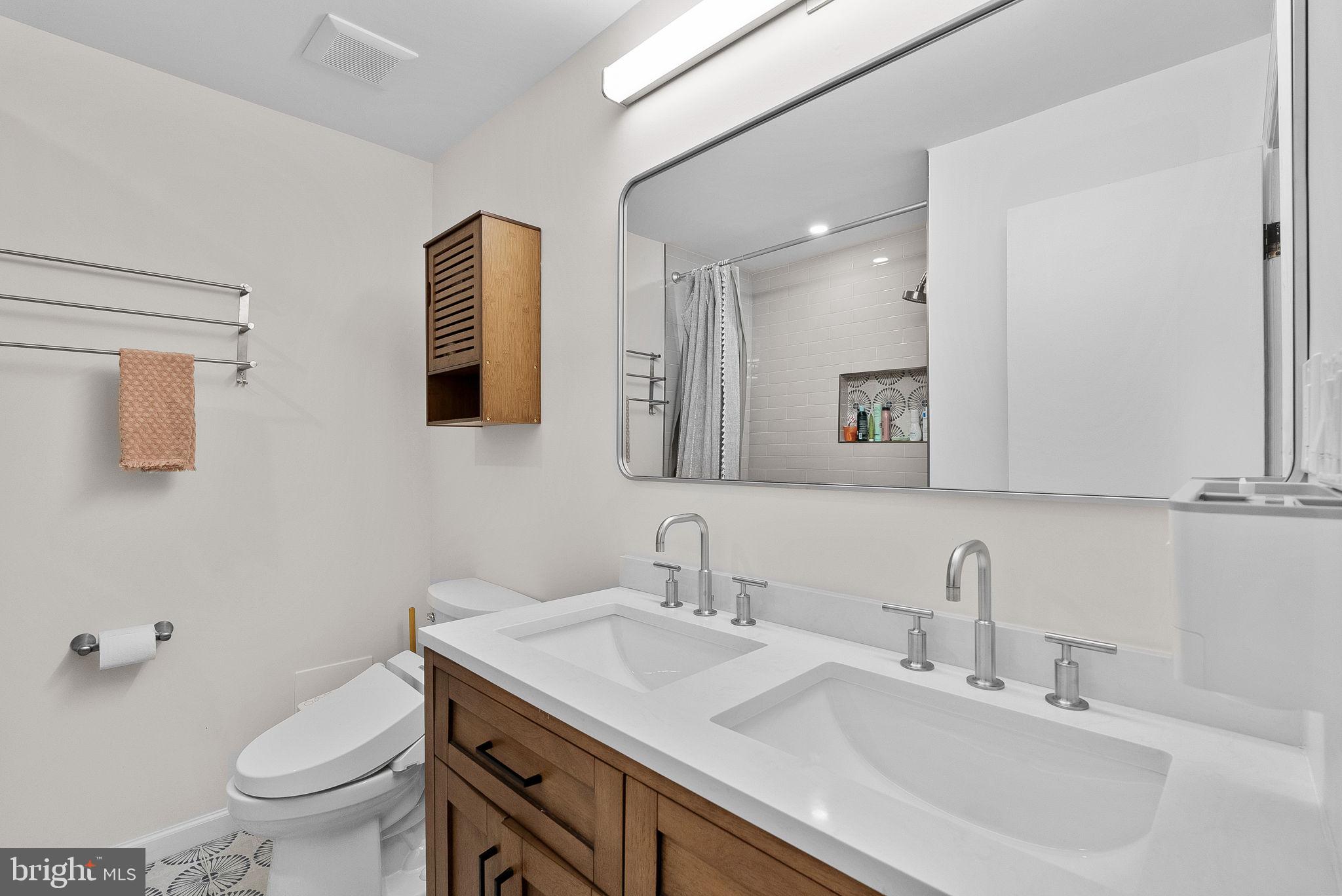 4119 27th Road North Arlington, VA 22207 - Photo 18 of 53 a bathroom with a toilet a sink a mirror and a window