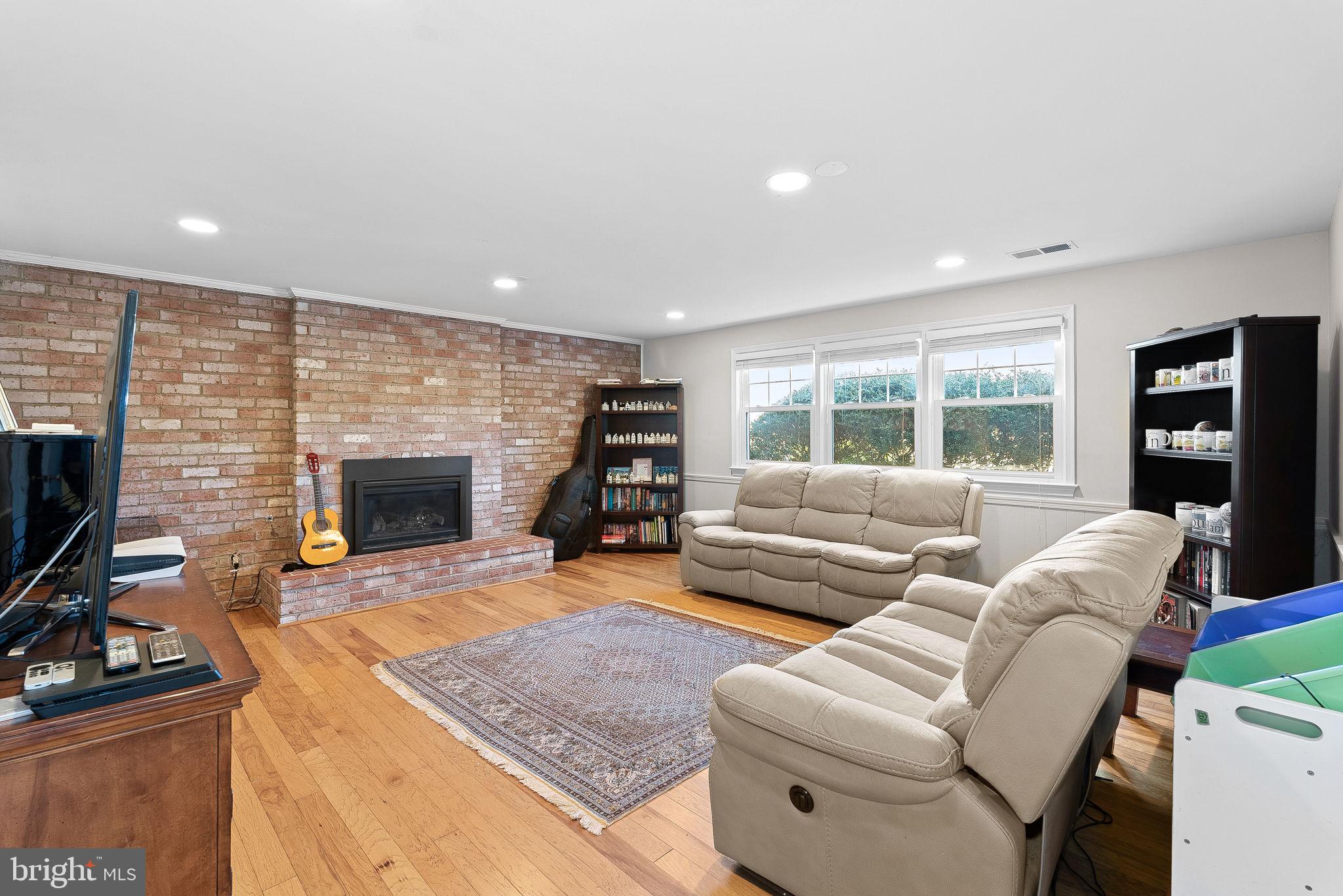 4119 27th Road North Arlington, VA 22207 - Photo 30 of 53 a living room with furniture a flat screen tv and a fireplace