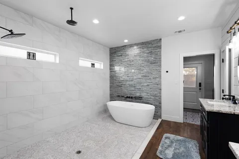 a bathroom with a granite countertop sink a toilet and shower