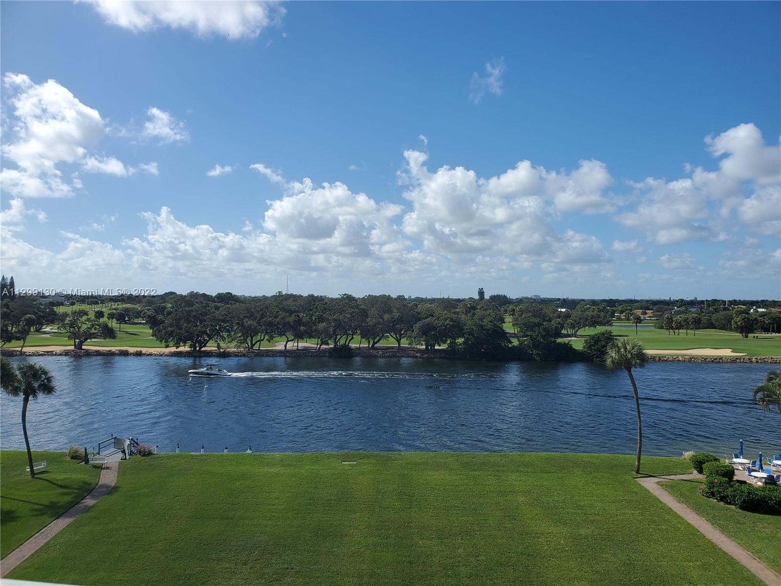 336 Golfview Road, Unit 502 North Palm Beach, FL 33408 - Photo 2 of 7 a view of a lake with houses in the back