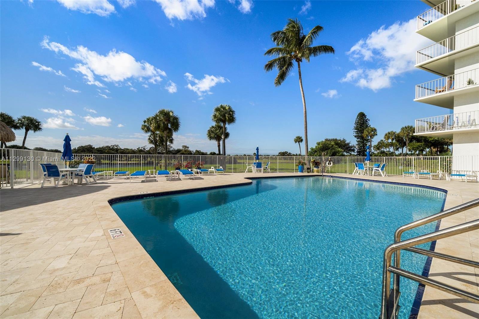 336 Golfview Road, Unit 502 North Palm Beach, FL 33408 - Photo 5 of 7 a view of a swimming pool with a table and chairs