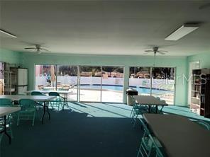 13250 Ridge Road, Unit 3B1 Largo, FL 33778 - Photo 14 of 15 a room with lots of table and chairs