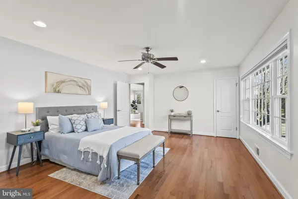 a kitchen with a refrigerator and white cabinets