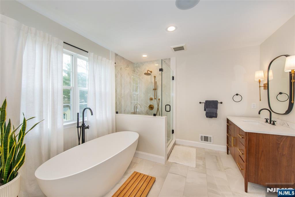 301 Cokesbury High Bridge Road Lebanon, NJ 08833 - Photo 12 of 31 a bathroom with a tub a sink and a large mirror