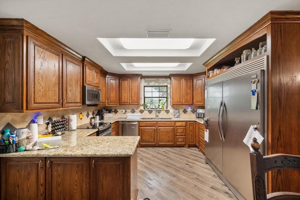 3748 Old Fort Worth Road Midlothian, TX 76065 - Photo 28 of 40 THIS KITCHEN IS A SHOW STOPPER! Gorgeous cabinetry, granite counters, stainless appliances. The built-in fridge is actually a full refrigerator on the right and a full freezer on the left.