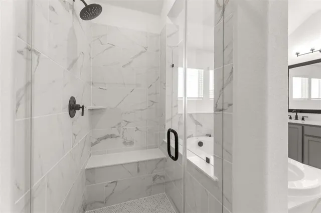 a bathroom with a bathtub and shower