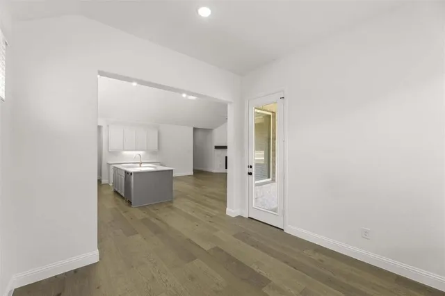 a view of a hallway with a kitchen