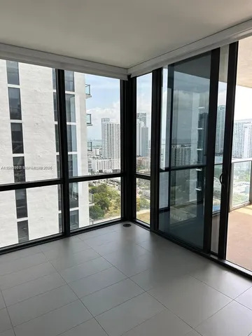 a view of an empty room with a large window