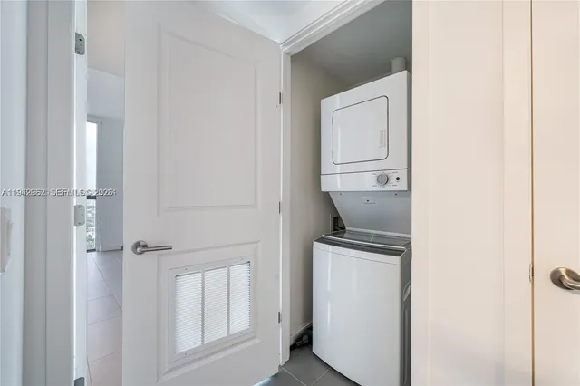 a room with a refrigerator and cabinets