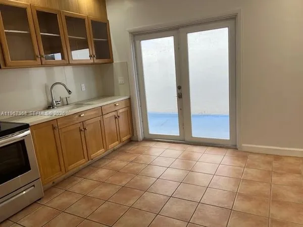 a kitchen with stainless steel appliances a sink and cabinets
