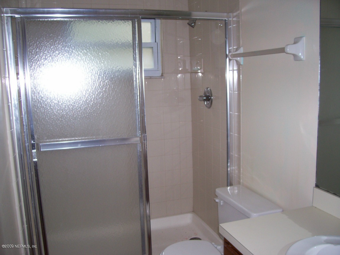 144 Martin Road St. Augustine, FL 32086 - Photo 8 of 10 a bathroom with a glass shower door