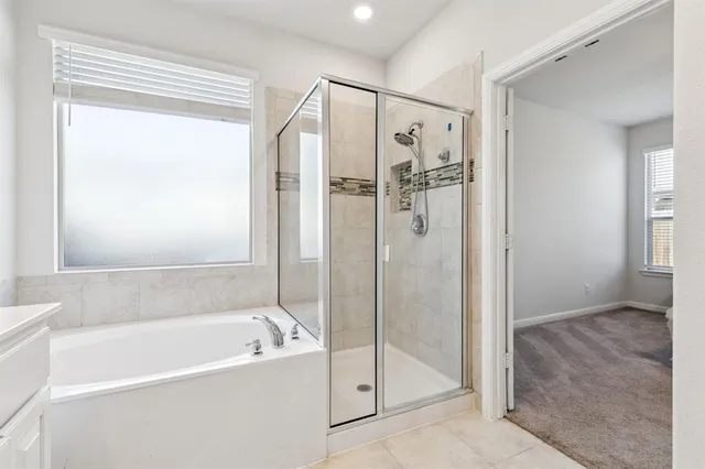 a bathroom with a bathtub and a shower