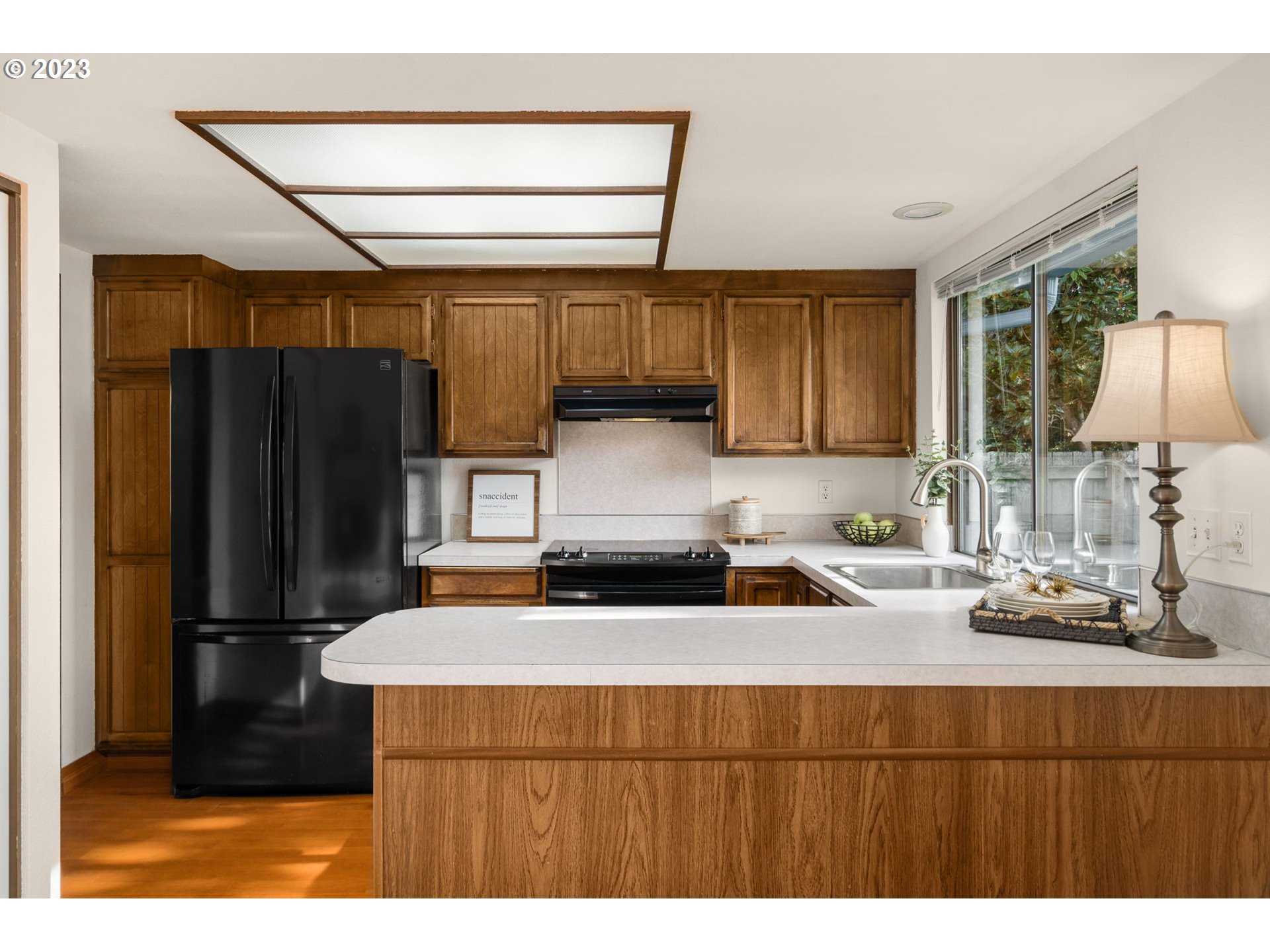 15735 Southwest Highland Court Portland, OR 97224 - Photo 11 of 39 a kitchen with kitchen island a counter top space cabinets and stainless steel appliances