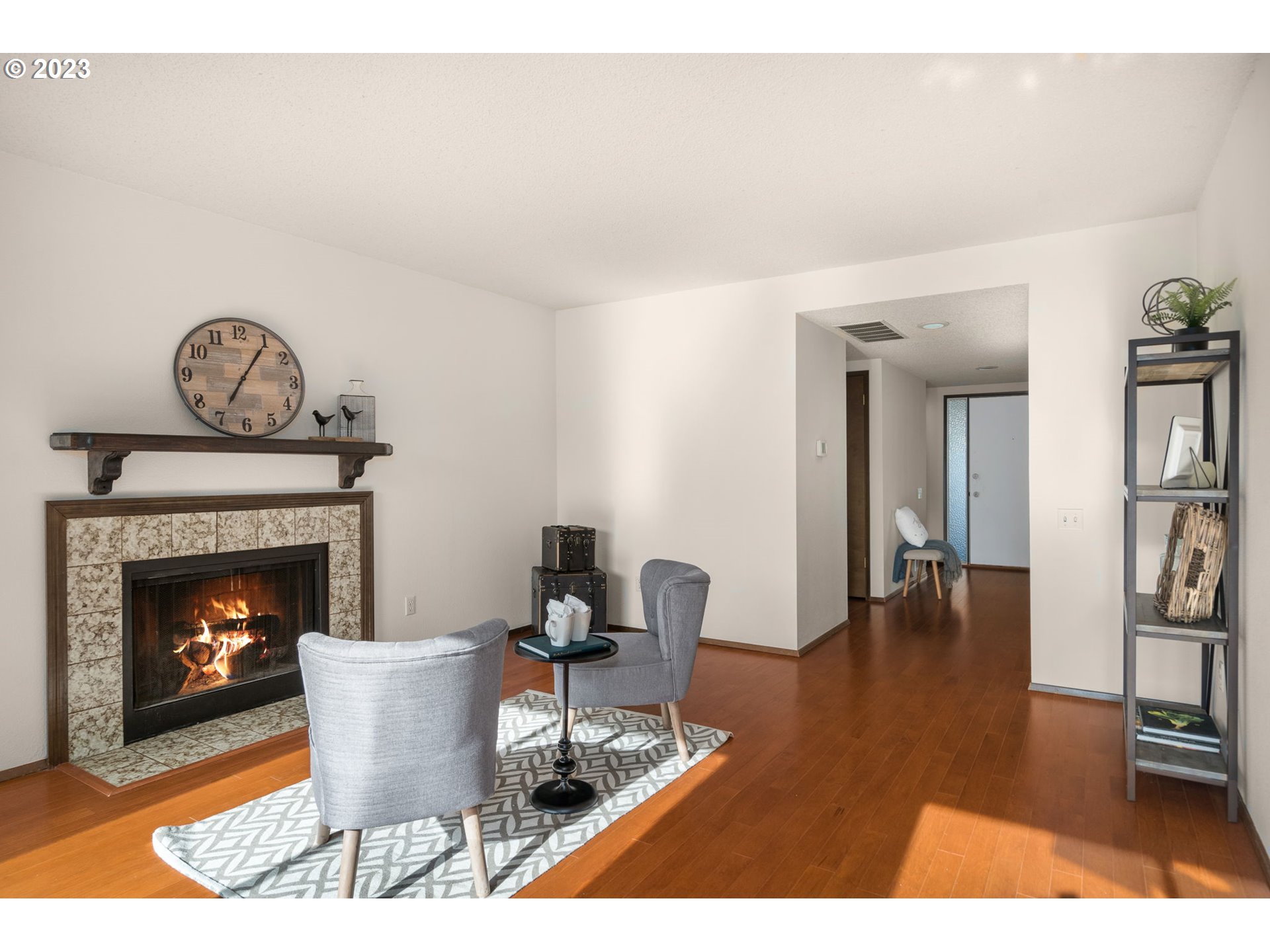 15735 Southwest Highland Court Portland, OR 97224 - Photo 13 of 39 a living room with furniture a fireplace and a table