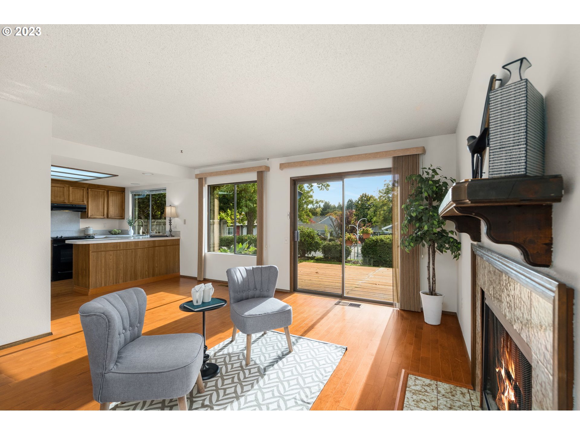 15735 Southwest Highland Court Portland, OR 97224 - Photo 15 of 39 a living room with furniture a fireplace and a floor to ceiling window