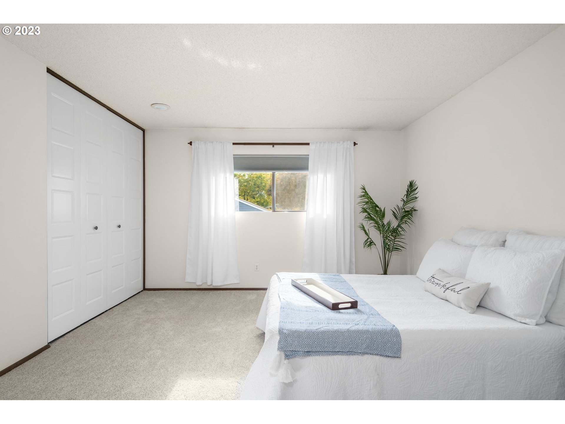 15735 Southwest Highland Court Portland, OR 97224 - Photo 21 of 39 a bedroom with a bed and a painting on the wall