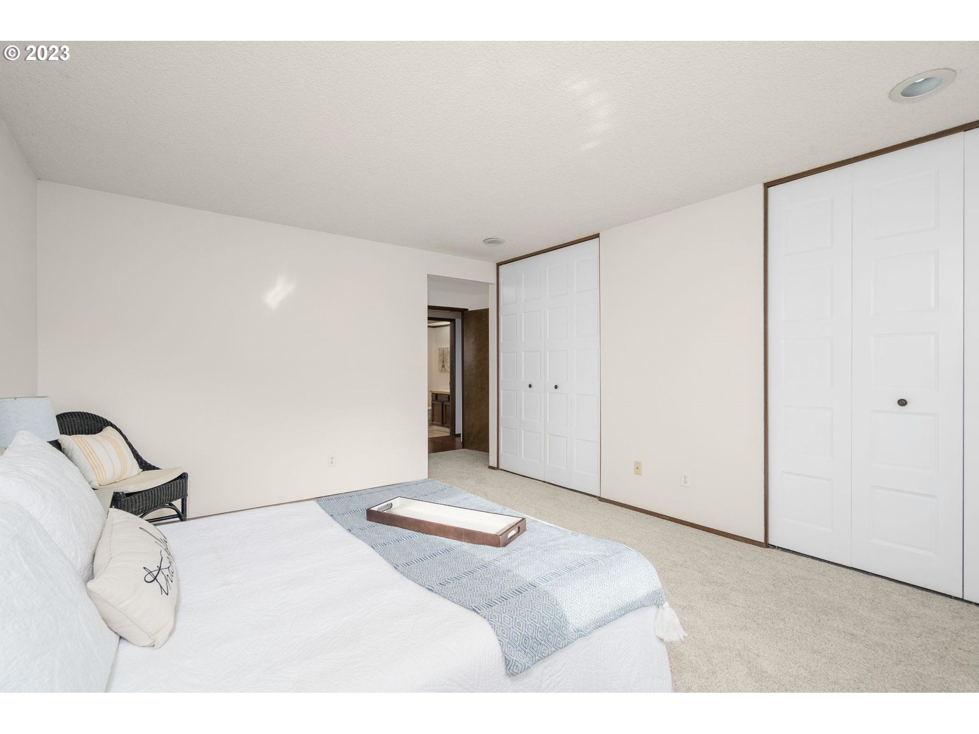 15735 Southwest Highland Court Portland, OR 97224 - Photo 22 of 39 a bedroom with a bed and cabinets