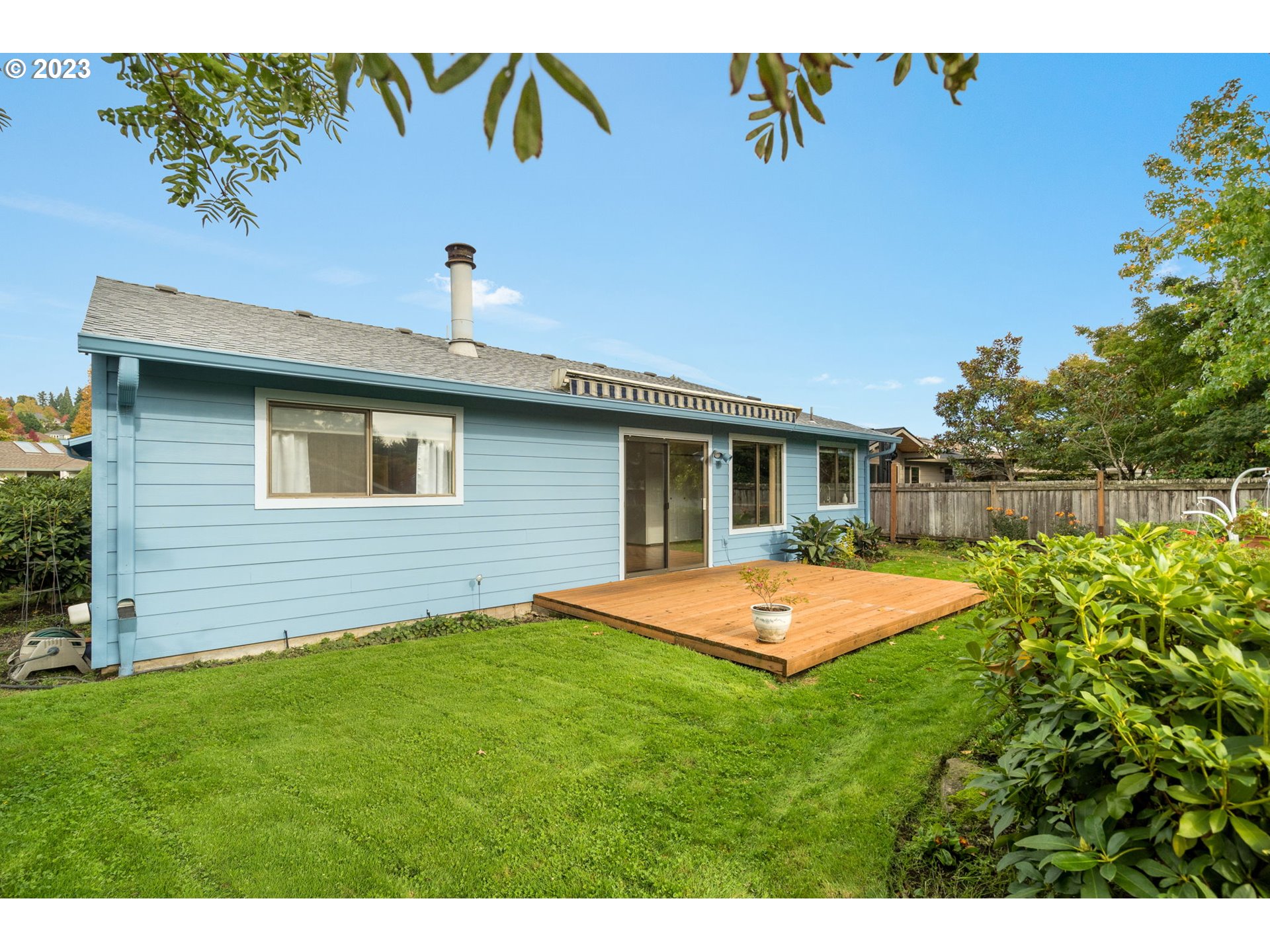 15735 Southwest Highland Court Portland, OR 97224 - Photo 25 of 39 a backyard of a house with table and chairs