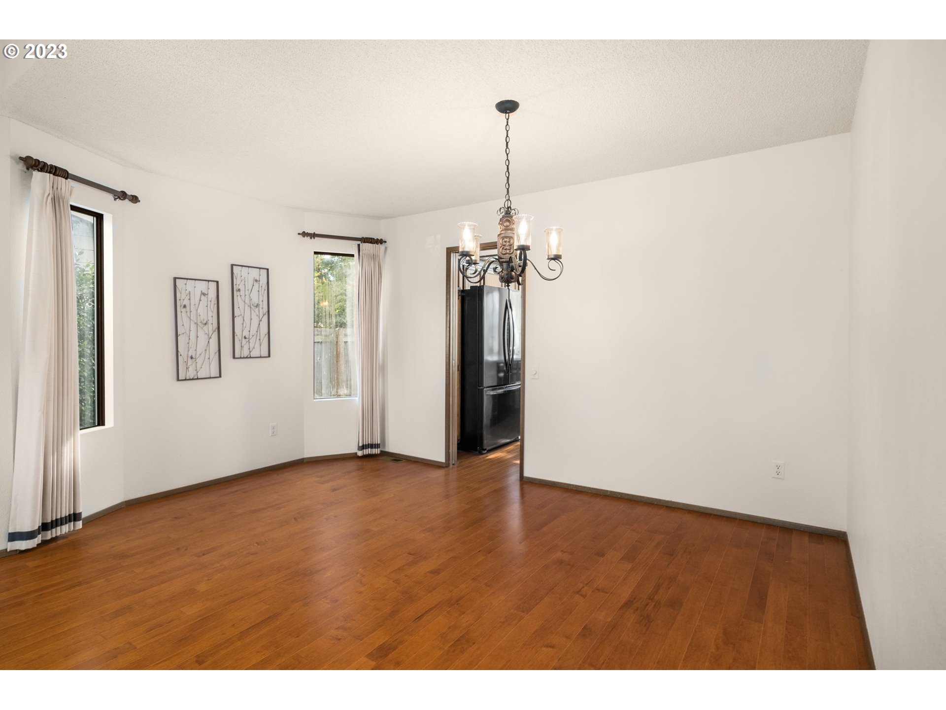 15735 Southwest Highland Court Portland, OR 97224 - Photo 8 of 39 a view of an empty room with window and wooden floor