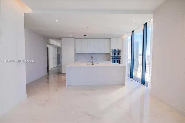 a kitchen with a faucet a sink and a window