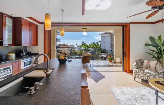 a living room with patio furniture and a large window
