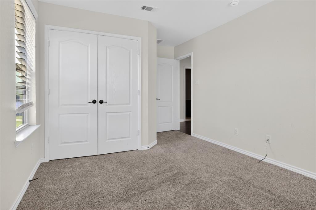 8728 Maple Ridge Trail Fort Worth, TX 76244 - Photo 33 of 40 Neutral wall paint, plush carpet flooring, white trim, and a window with blinds