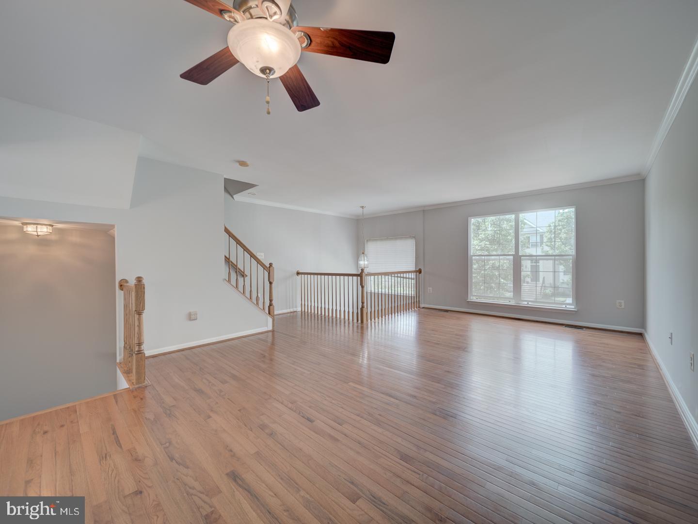 8241 Humphrey Lane Manassas, VA 20109 - Photo 11 of 55 a view of an empty room with wooden floor and a window