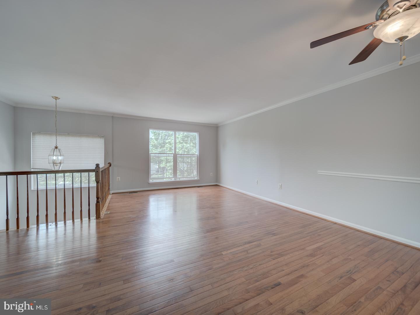 8241 Humphrey Lane Manassas, VA 20109 - Photo 13 of 55 a view of an empty room with wooden floor and a window