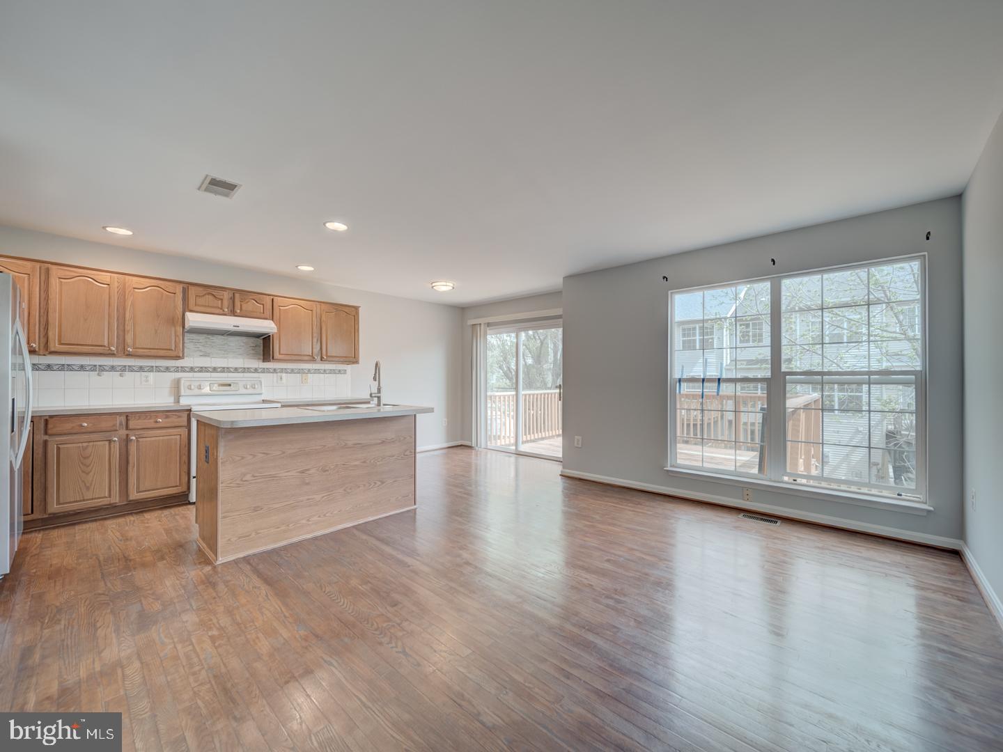 8241 Humphrey Lane Manassas, VA 20109 - Photo 17 of 55 a large kitchen with stainless steel appliances granite countertop a large counter top a wooden floors and a large window