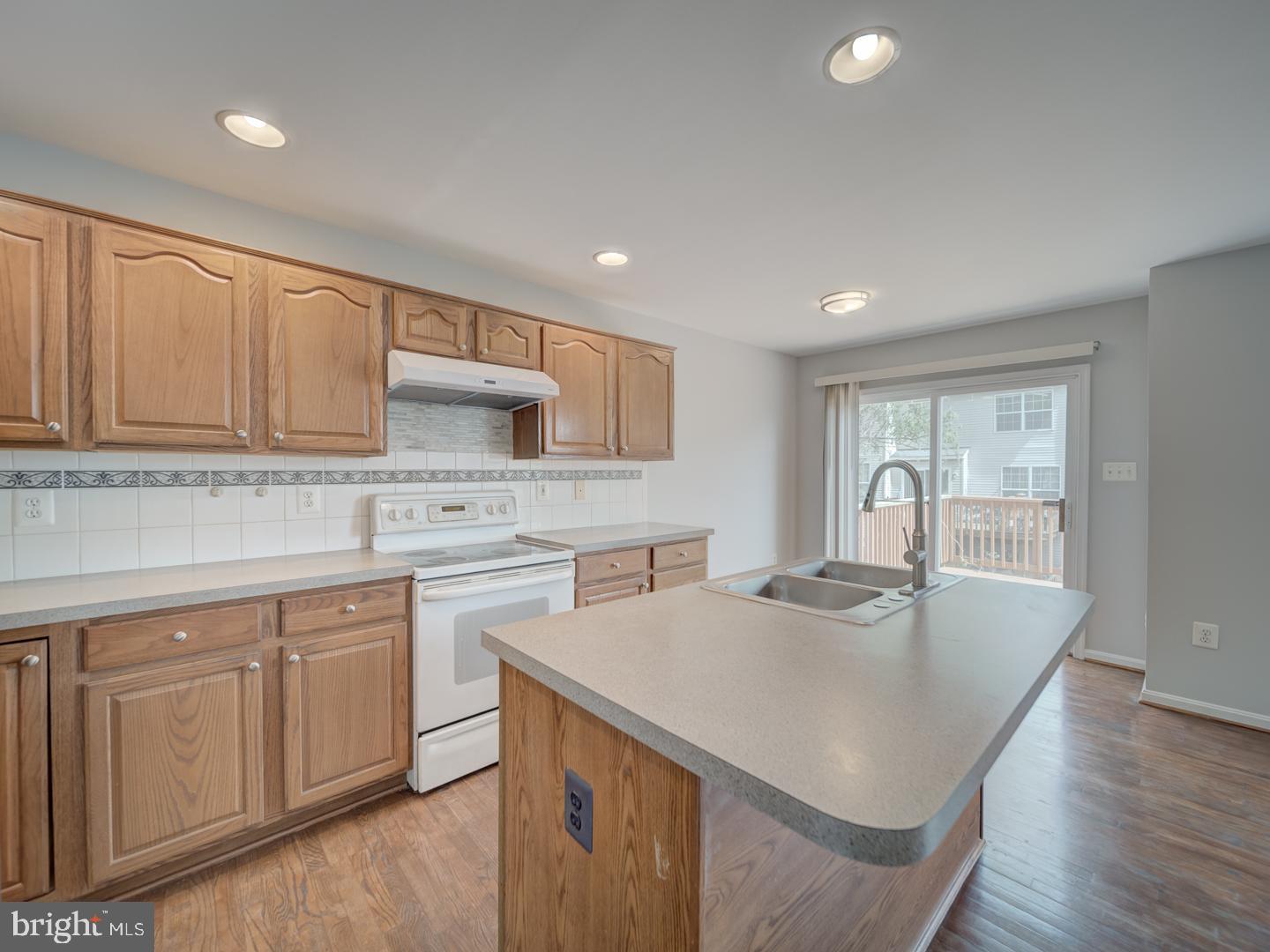 8241 Humphrey Lane Manassas, VA 20109 - Photo 22 of 55 a kitchen with sink cabinets and wooden floor