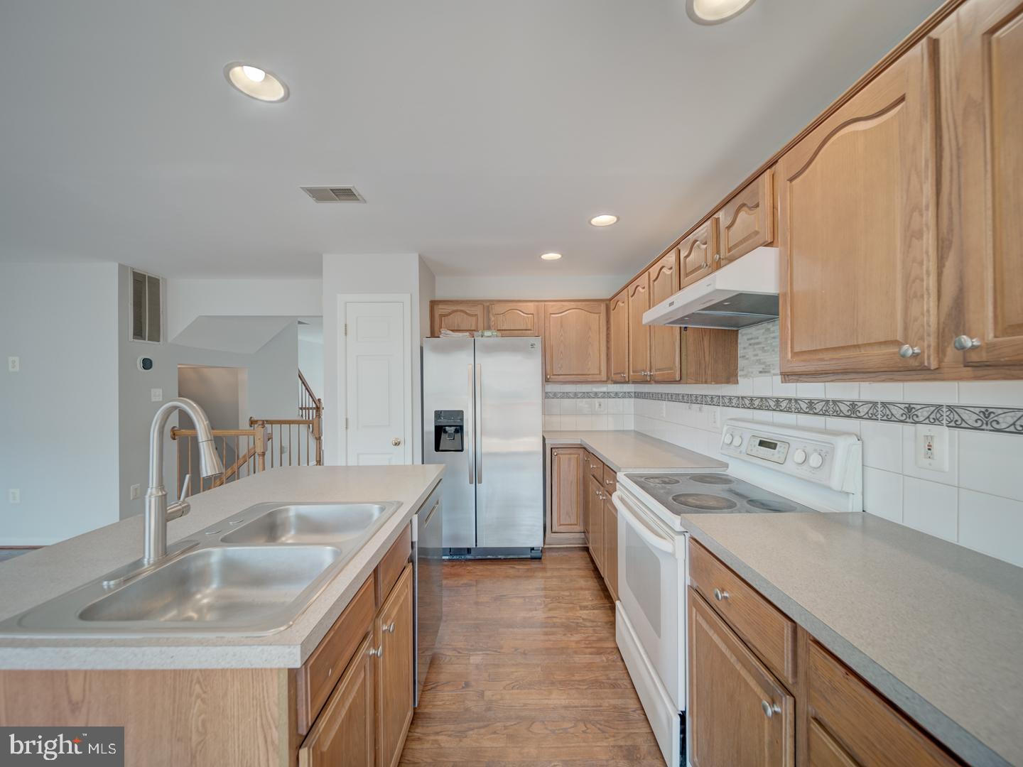 8241 Humphrey Lane Manassas, VA 20109 - Photo 24 of 55 a kitchen with a sink stove and refrigerator