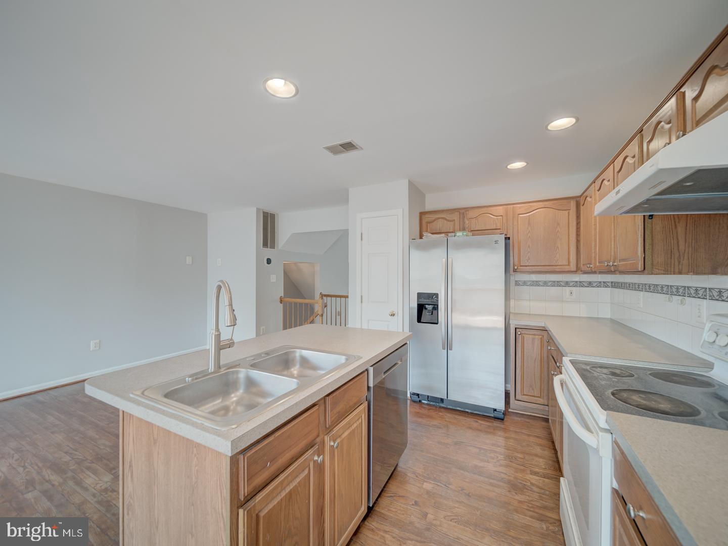 8241 Humphrey Lane Manassas, VA 20109 - Photo 25 of 55 a kitchen with a sink stove and refrigerator