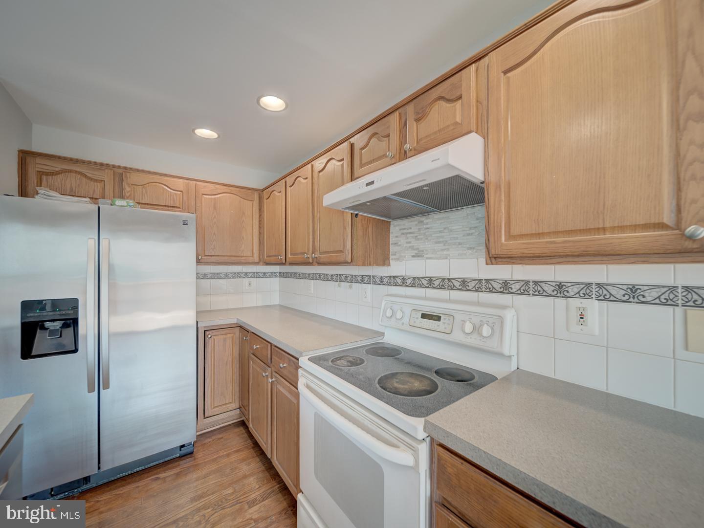 8241 Humphrey Lane Manassas, VA 20109 - Photo 26 of 55 a kitchen with a sink a refrigerator and cabinets