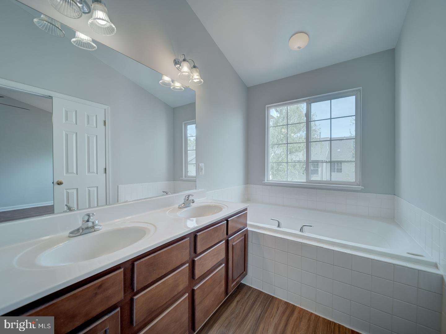 8241 Humphrey Lane Manassas, VA 20109 - Photo 36 of 55 a bathroom with a sink double vanity granite tub and a mirror