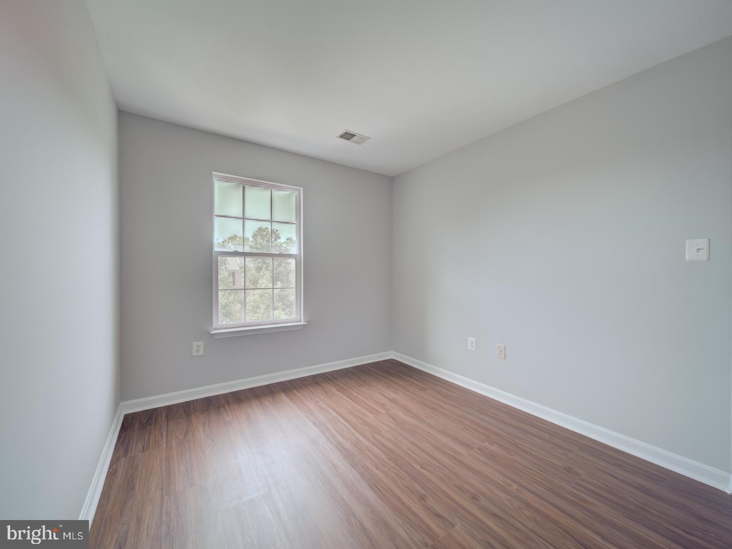 8241 Humphrey Lane Manassas, VA 20109 - Photo 40 of 55 an empty room with wooden floor and windows