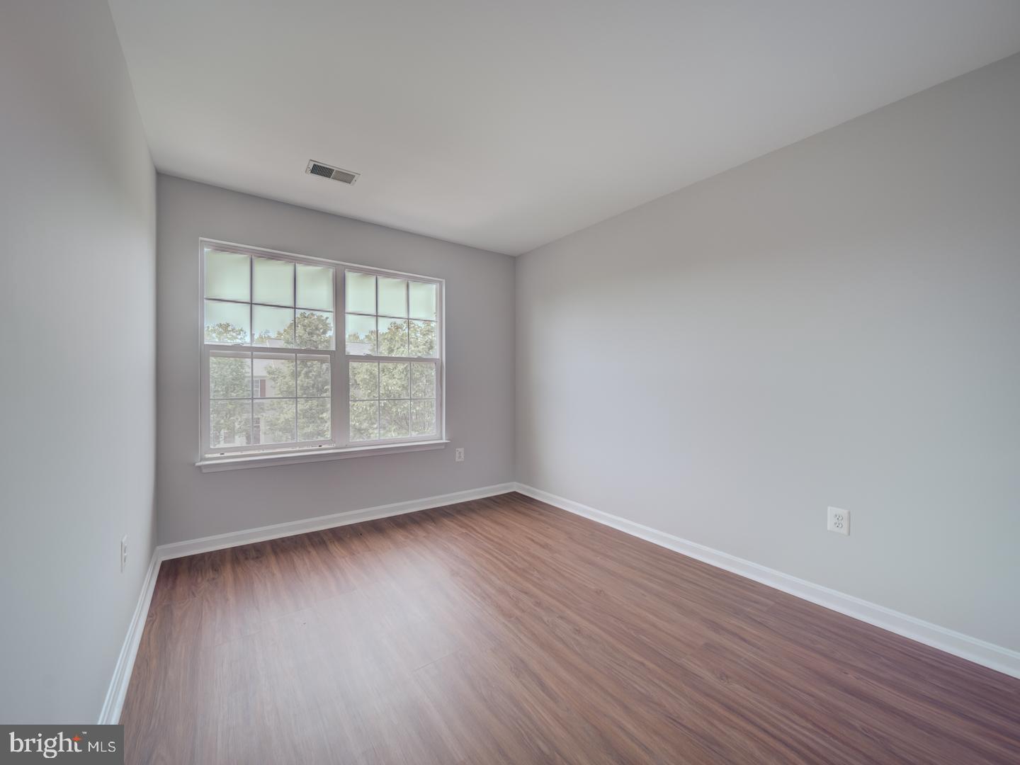 8241 Humphrey Lane Manassas, VA 20109 - Photo 43 of 55 an empty room with wooden floor and windows