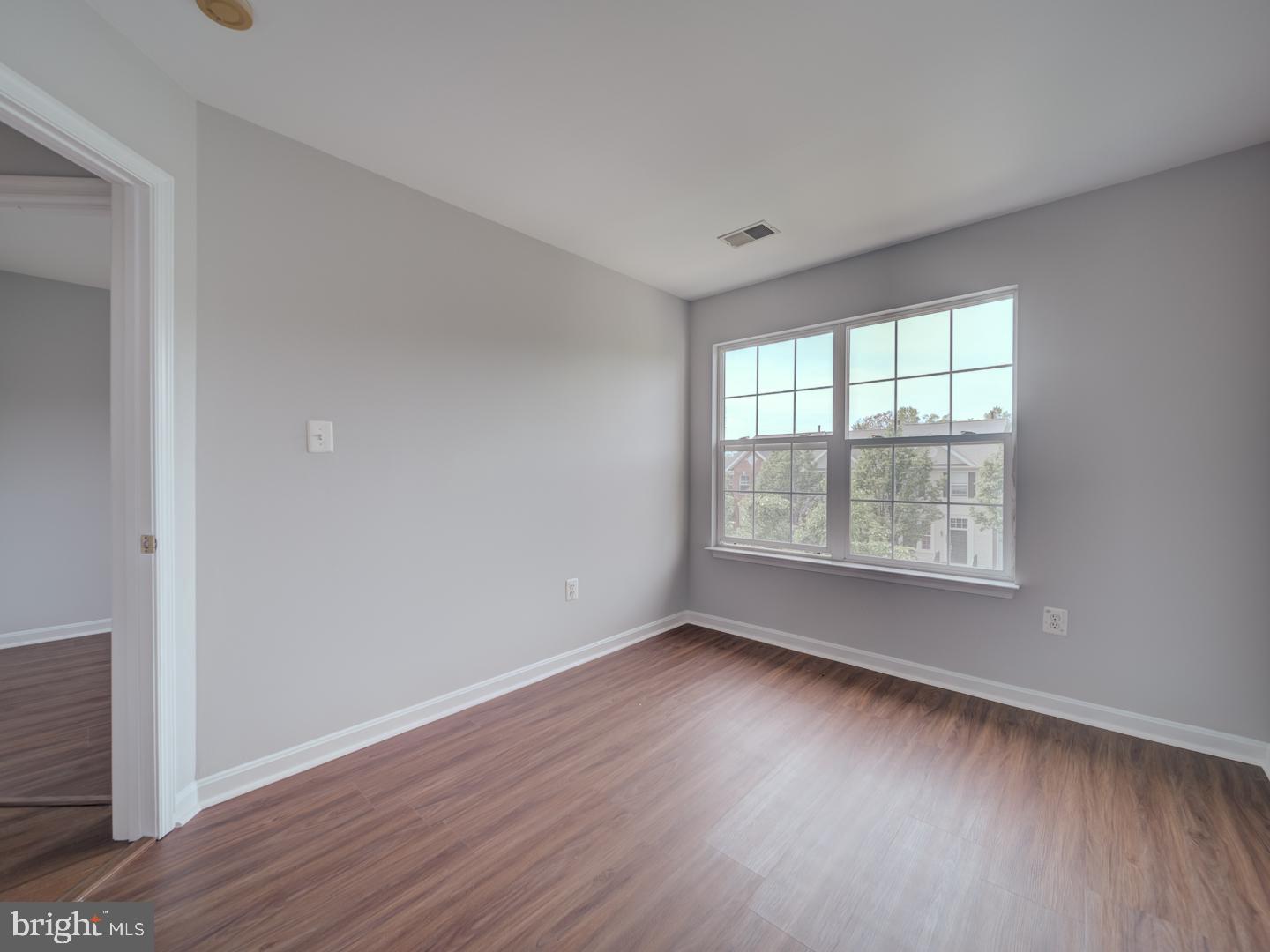8241 Humphrey Lane Manassas, VA 20109 - Photo 44 of 55 an empty room with wooden floor and windows
