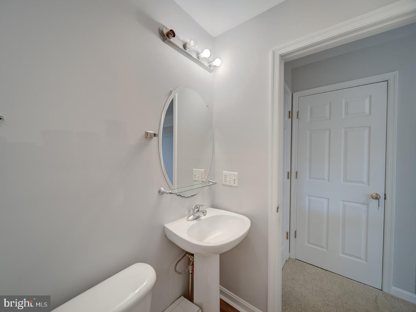 8241 Humphrey Lane Manassas, VA 20109 - Photo 55 of 55 a bathroom with a sink a toilet and mirror