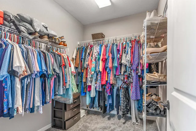 a view of walk in closet with clothes