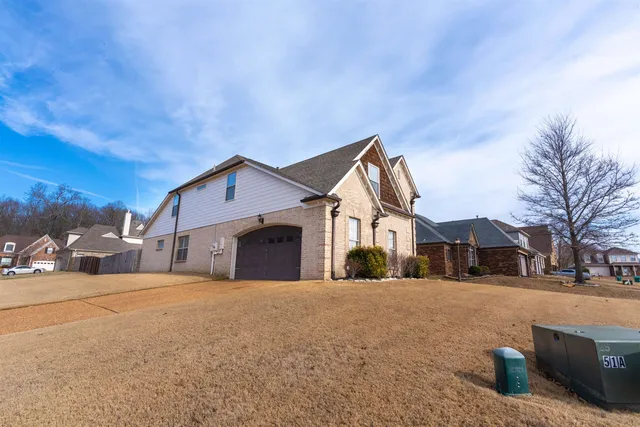 a view of a white house with a yard
