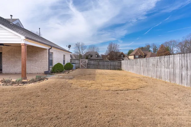 a view of a backyard of the house