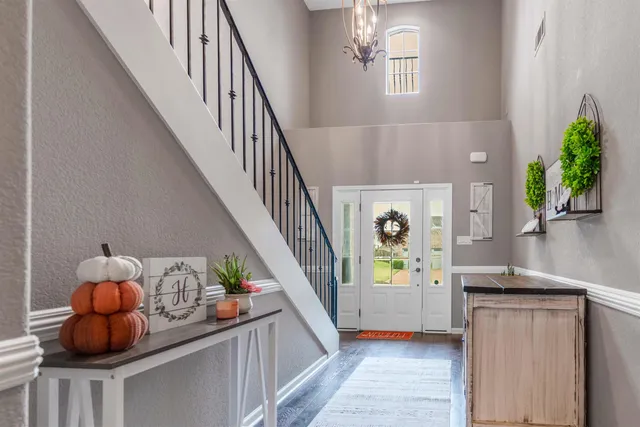 a view of entryway and hall with wooden floor