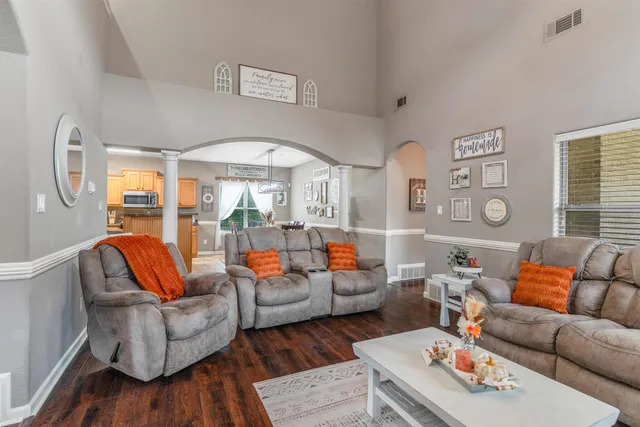 a living room with furniture a rug and a large window